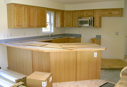 VIEW OF KITCHEN AS DELIVERED WITH STANDARD COUNTERTOP STANDARD RAISED PANEL OAK CABINETS AND OPTIONAL SPACE SAVER MICROWAVE FACTORY INSTALLED